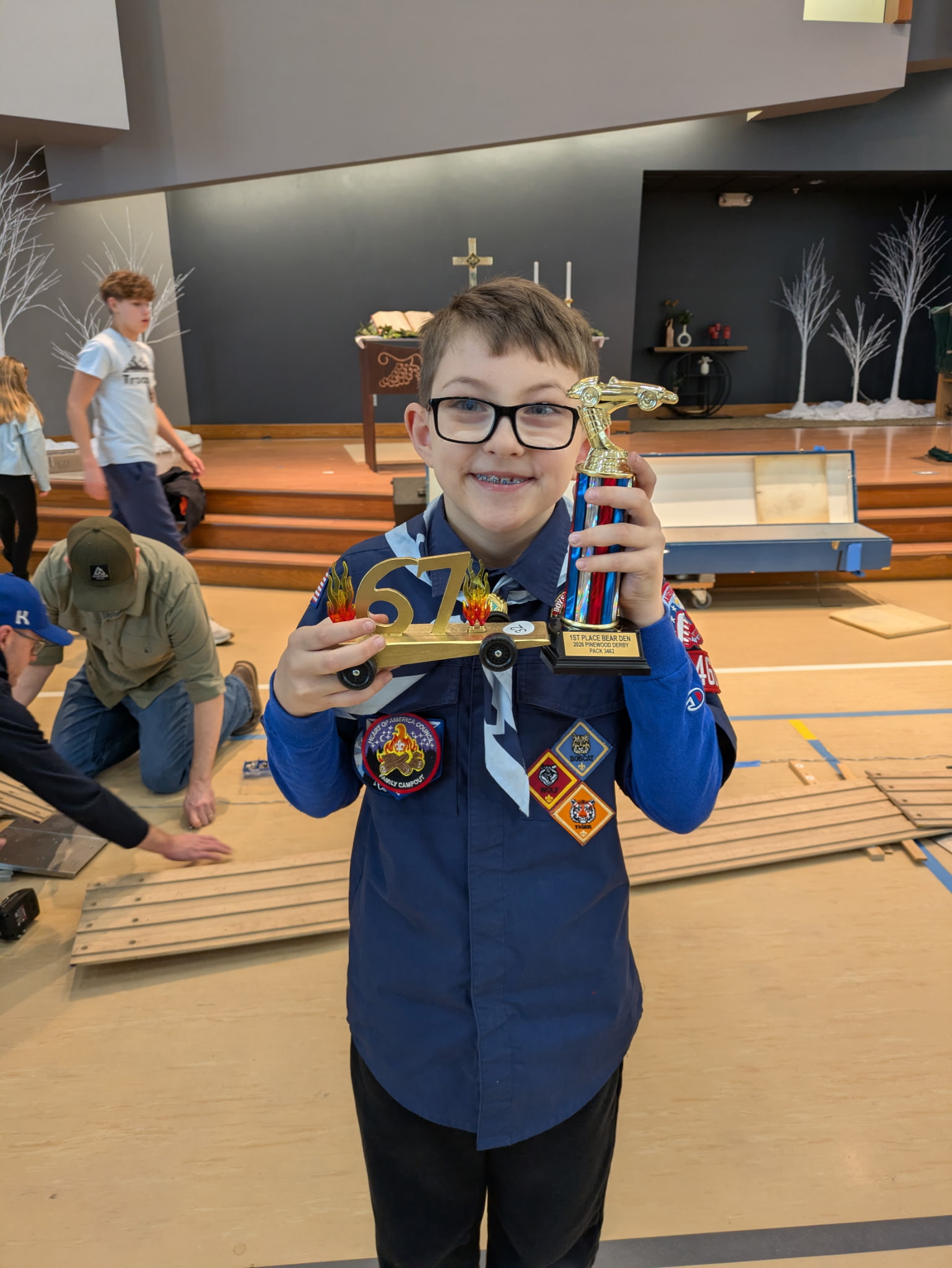 Scout with pinewood derby trophy