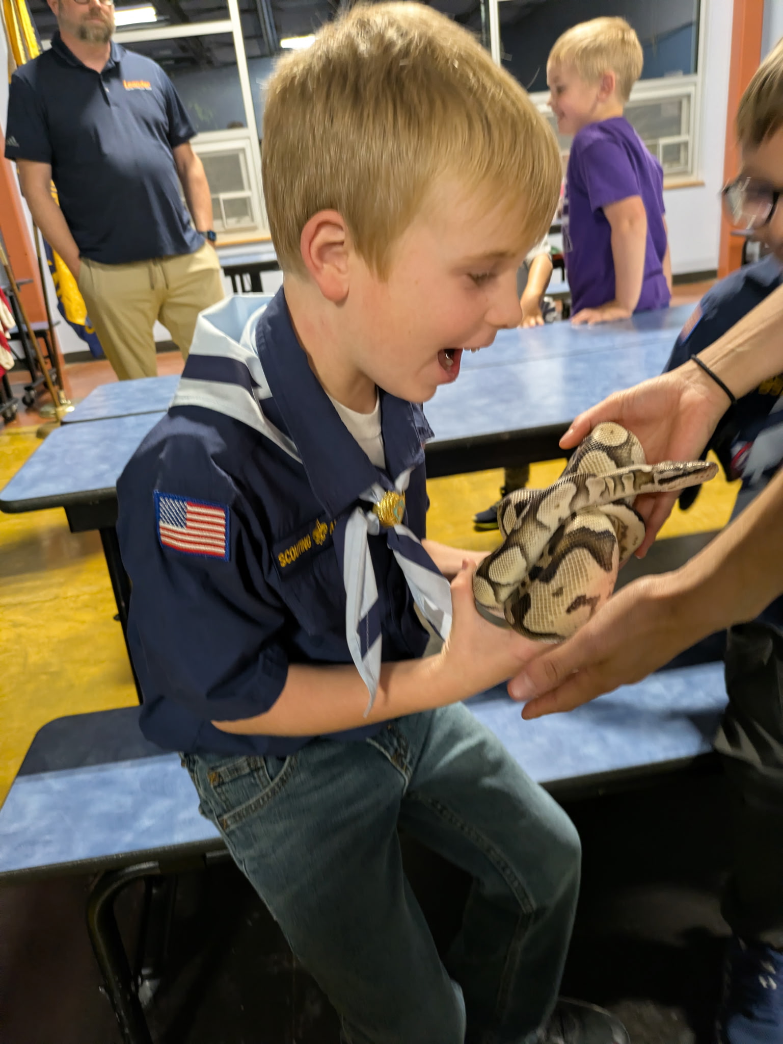 Scout holding a snake